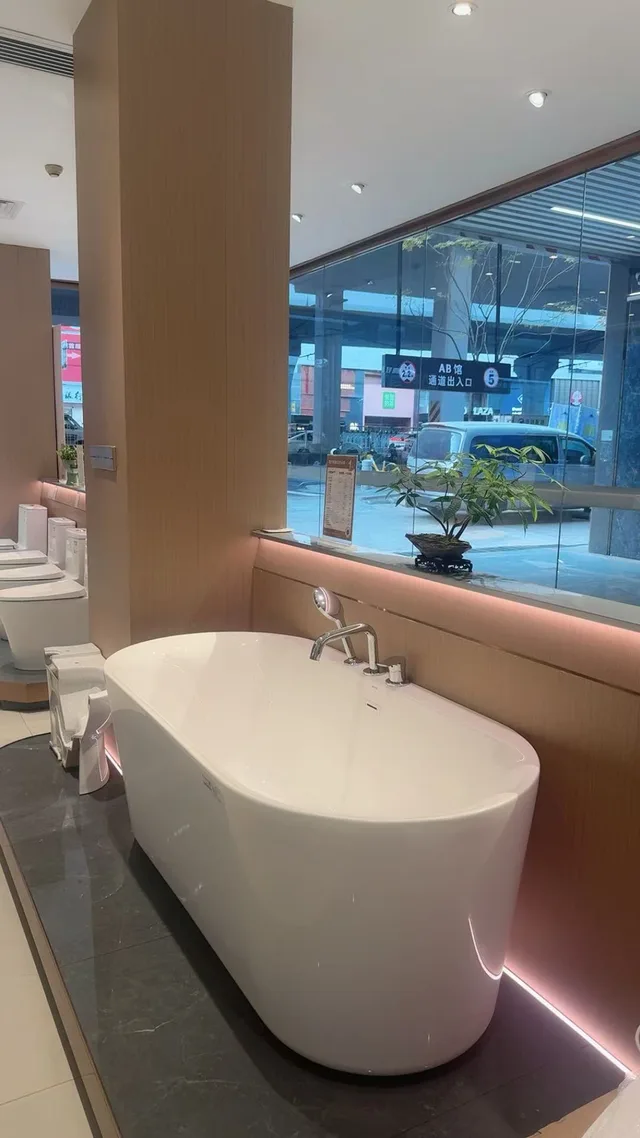 Freestanding tub beside a window in a bathroom showroom