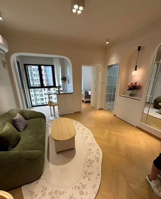 Wood-tone flooring running through a living area and adjoining doorway